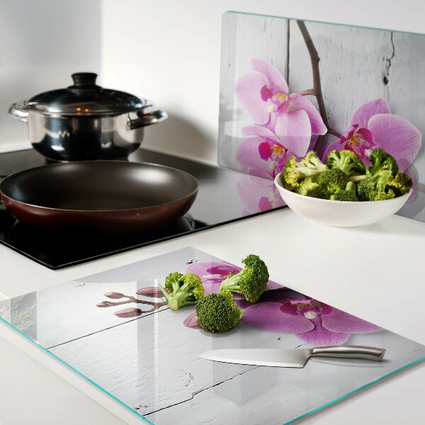 Tagliere in vetro temperato con motivo di orchidee su sfondo bianco