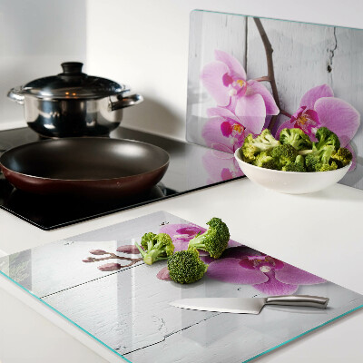 Tagliere in vetro temperato con motivo di orchidee su sfondo bianco