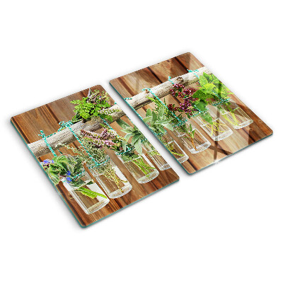 Tagliere in vetro temperato con motivo di erbe in barattoli su sfondo di legno