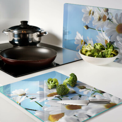 Tagliere in vetro con motivo di fiori di margherita su sfondo blu