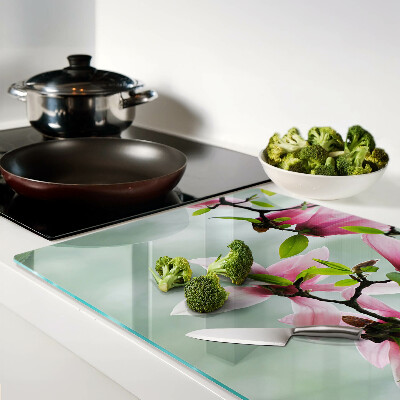 Tagliere in vetro temperato con motivo di fiori di magnolia su sfondo verde