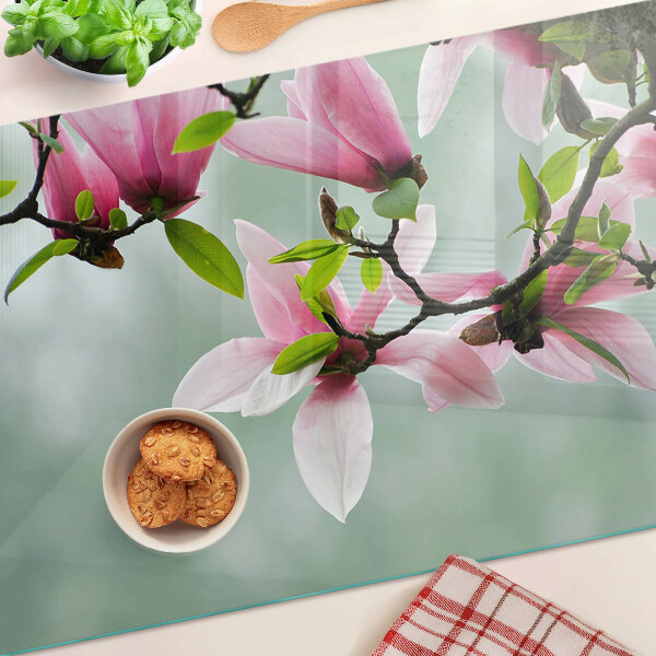 Tagliere in vetro temperato con motivo di fiori di magnolia su sfondo verde
