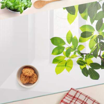 Tagliere in vetro temperato con motivo di foglie su sfondo cielo chiaro