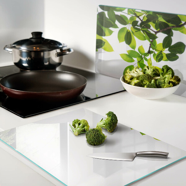 Tagliere in vetro temperato con motivo di foglie su sfondo cielo chiaro