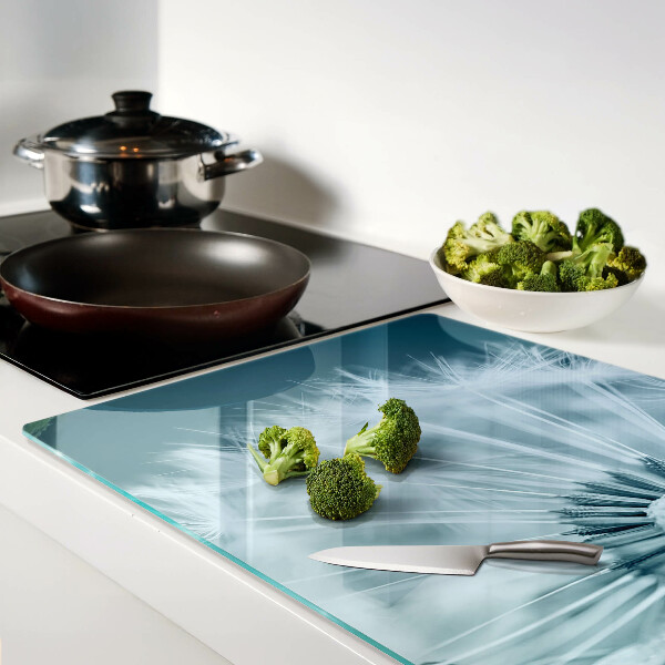 Tagliere in vetro temperato con motivo di denti di leone su sfondo cielo