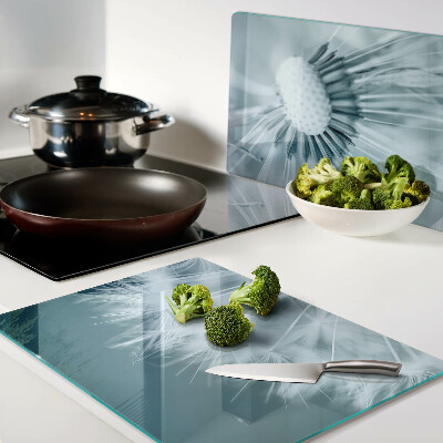 Tagliere in vetro temperato con motivo di denti di leone su sfondo cielo