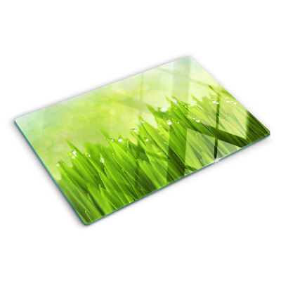 Tagliere in vetro con stampa di erba verde con gocce d'acqua