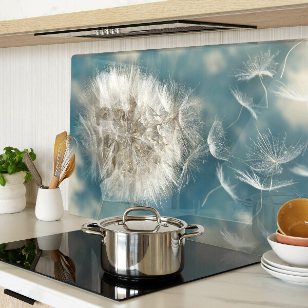 Tagliere in vetro con motivo di denti di leone su sfondo azzurro