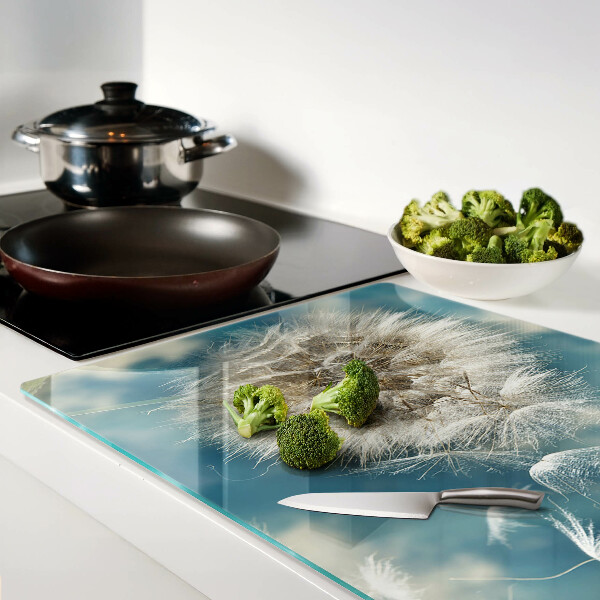 Tagliere in vetro con motivo di denti di leone su sfondo azzurro