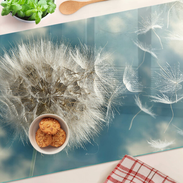 Tagliere in vetro con motivo di denti di leone su sfondo azzurro