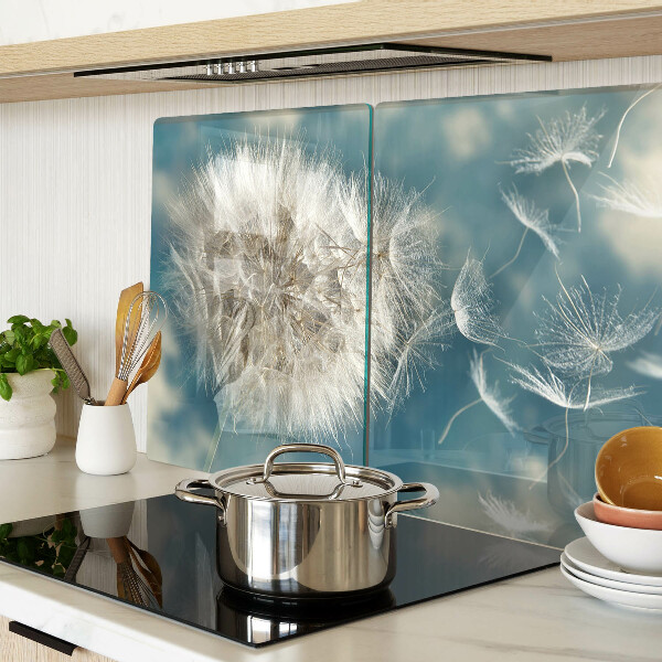 Tagliere in vetro con motivo di denti di leone su sfondo azzurro