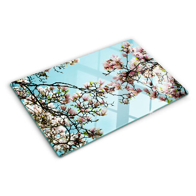 Tagliere in vetro con motivo di fiori di magnolia su sfondo blu