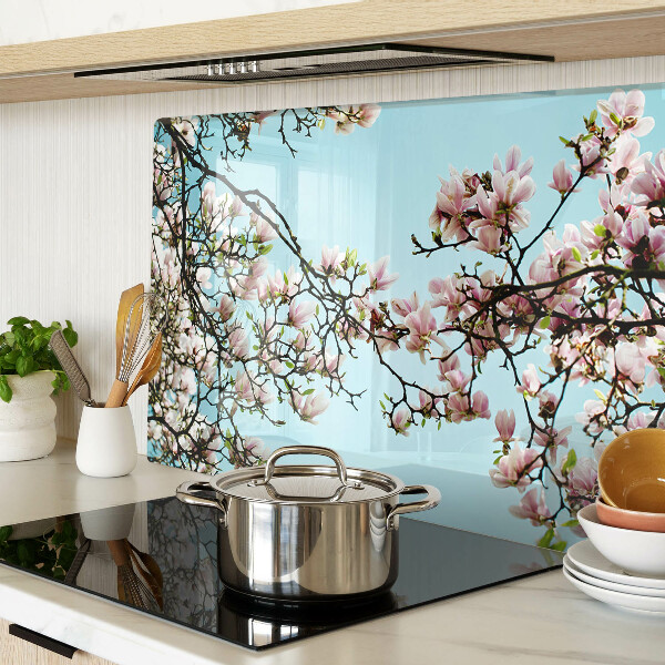 Tagliere in vetro con motivo di fiori di magnolia su sfondo blu