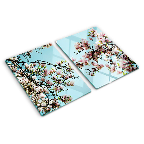 Tagliere in vetro con motivo di fiori di magnolia su sfondo blu