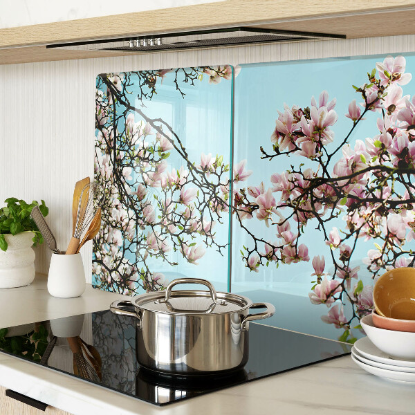 Tagliere in vetro con motivo di fiori di magnolia su sfondo blu