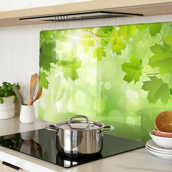 Tagliere in vetro temperato con motivo di foglie illuminate dai raggi del sole