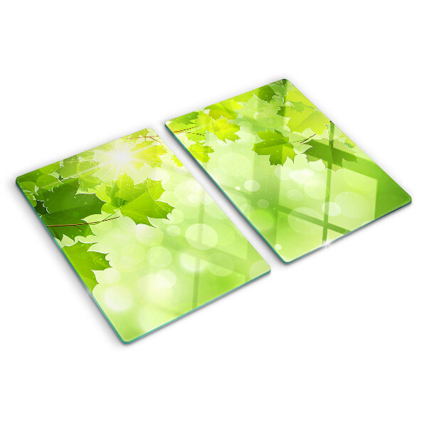 Tagliere in vetro temperato con motivo di foglie illuminate dai raggi del sole
