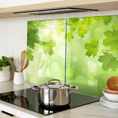 Tagliere in vetro temperato con motivo di foglie illuminate dai raggi del sole