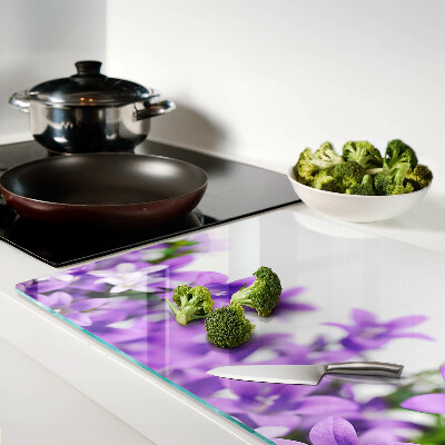 Tagliere in vetro con motivo di fiori viola sullo sfondo