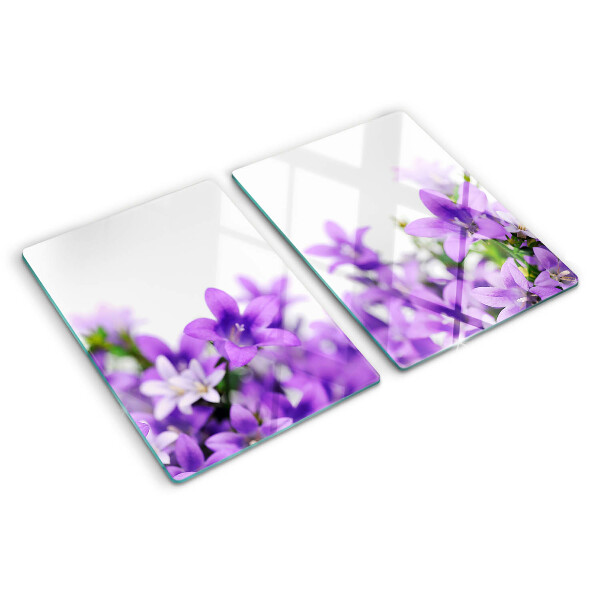 Tagliere in vetro con motivo di fiori viola sullo sfondo