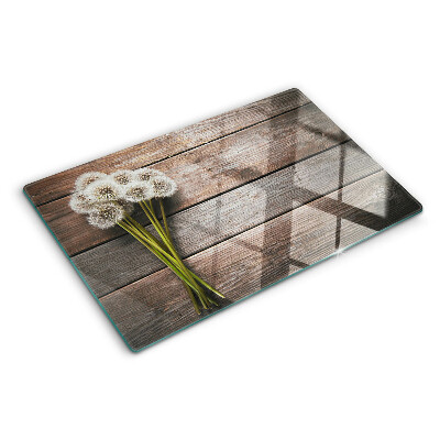 Tagliere in vetro temperato con motivo di fiori e soffioni su sfondo legno