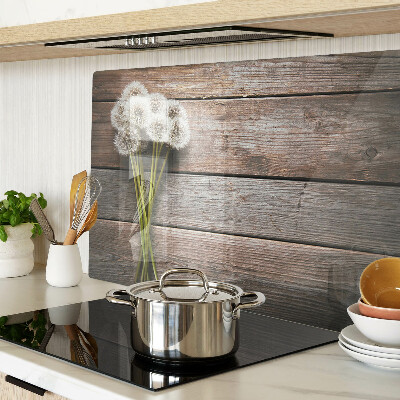 Tagliere in vetro temperato con motivo di fiori e soffioni su sfondo legno