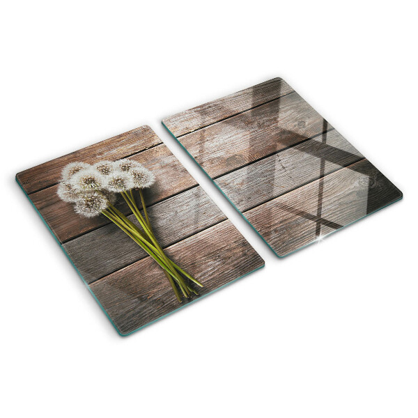 Tagliere in vetro temperato con motivo di fiori e soffioni su sfondo legno