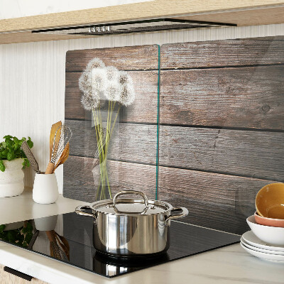 Tagliere in vetro temperato con motivo di fiori e soffioni su sfondo legno