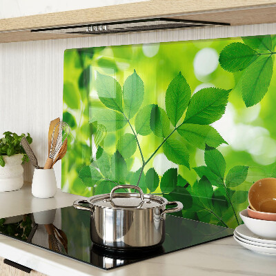 Tagliere in vetro temperato con motivo di foglie su sfondo verde