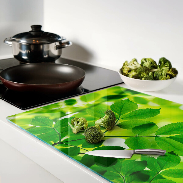 Tagliere in vetro temperato con motivo di foglie su sfondo verde