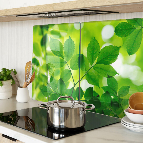 Tagliere in vetro temperato con motivo di foglie su sfondo verde