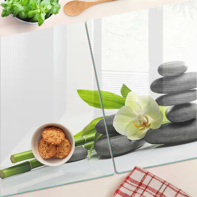 Tagliere in vetro temperato con stampa a tema orchidea e con motivo a pietre in stile spa