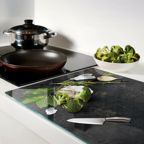 Tagliere in vetro temperato con motivo di fiori ed erbe su sfondo marmoreo