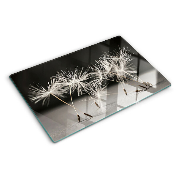 Tagliere in vetro con motivo di soffici denti di leone su sfondo monocromatico