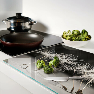 Tagliere in vetro con motivo di soffici denti di leone su sfondo monocromatico