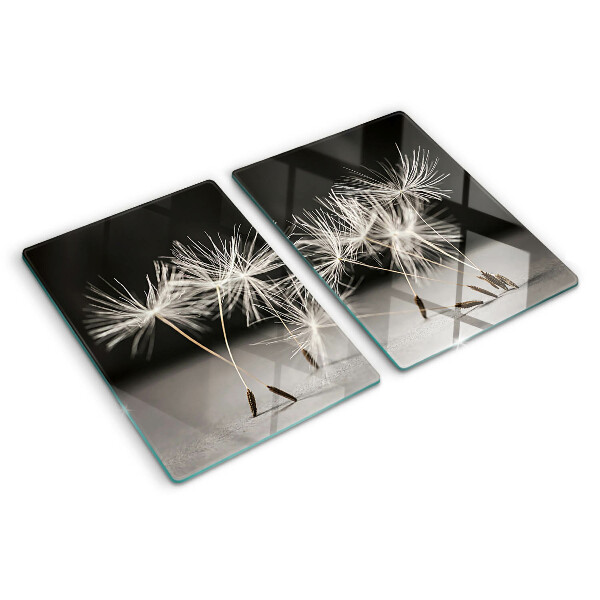 Tagliere in vetro con motivo di soffici denti di leone su sfondo monocromatico