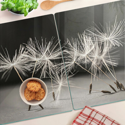 Tagliere in vetro con motivo di soffici denti di leone su sfondo monocromatico