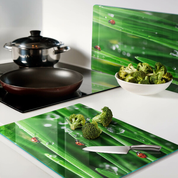 Tagliere in vetro con motivo gocce d'acqua sull'erba e coccinelle