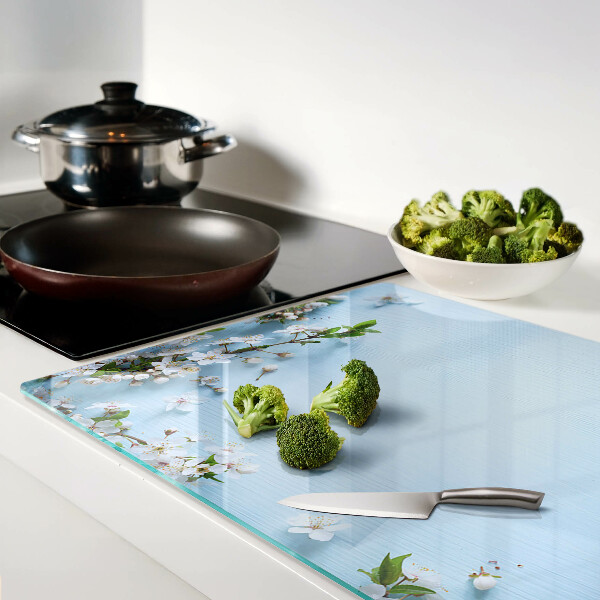 Tagliere in vetro con motivo floreale su fondo blu