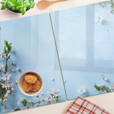 Tagliere in vetro con motivo floreale su fondo blu