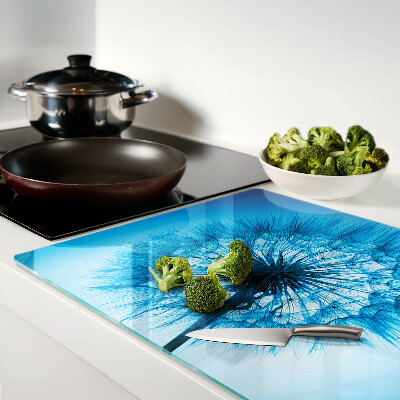 Tagliere in vetro con motivo di dente di leone su sfondo blu