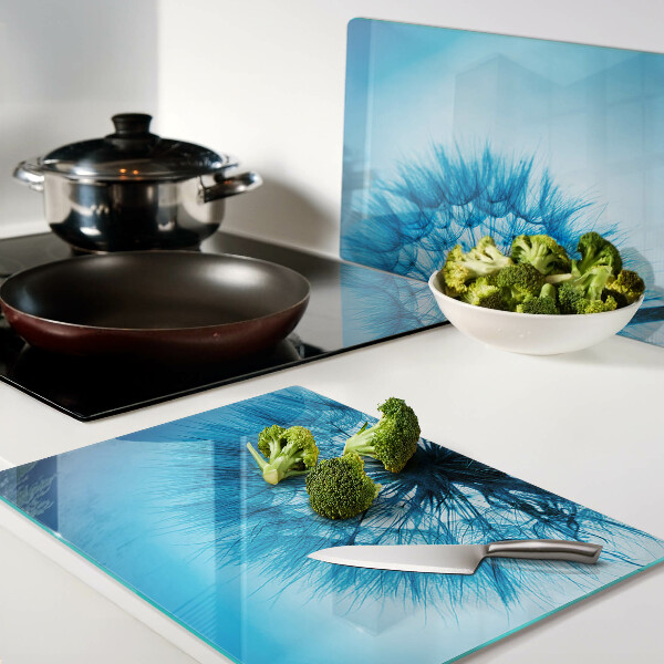 Tagliere in vetro con motivo di dente di leone su sfondo blu