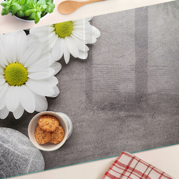 Tagliere in vetro temperato con decorazione a fiori e motivi pietrosi sullo sfondo