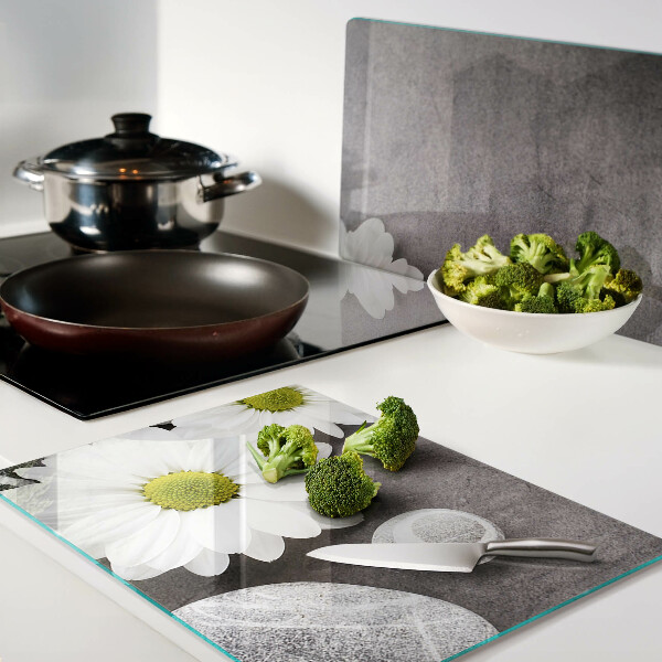 Tagliere in vetro temperato con decorazione a fiori e motivi pietrosi sullo sfondo