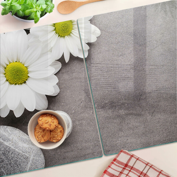 Tagliere in vetro temperato con decorazione a fiori e motivi pietrosi sullo sfondo