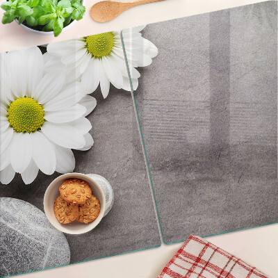 Tagliere in vetro temperato con decorazione a fiori e motivi pietrosi sullo sfondo