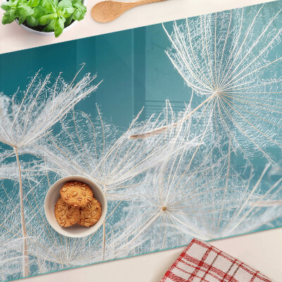 Tagliere in vetro temperato con motivo di denti di leone su sfondo blu