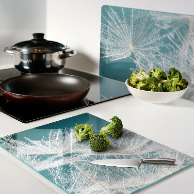 Tagliere in vetro temperato con motivo di denti di leone su sfondo blu