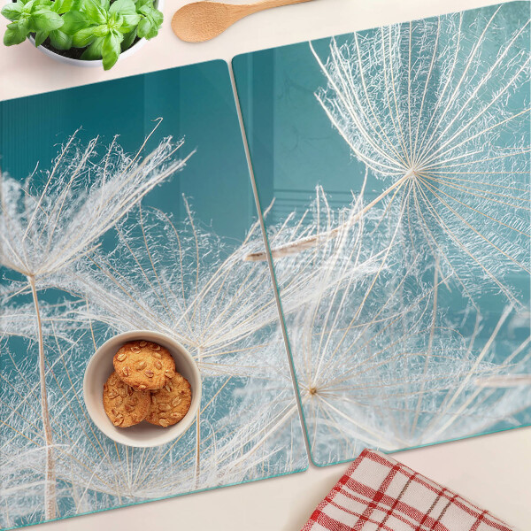 Tagliere in vetro temperato con motivo di denti di leone su sfondo blu