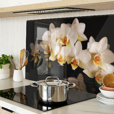 Tagliere in vetro con stampa di orchidee su sfondo nero